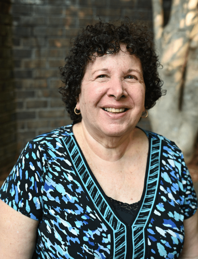 headshot of a woman posing in front of elevated landscaping